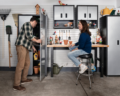 Man opening Gladiator Gearbox Cabinet while woman smiles at him.