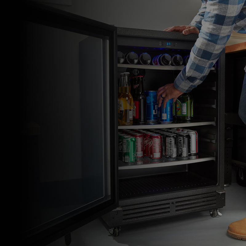 A person grabbing a beverage out of the Gladiator® beverage cooler