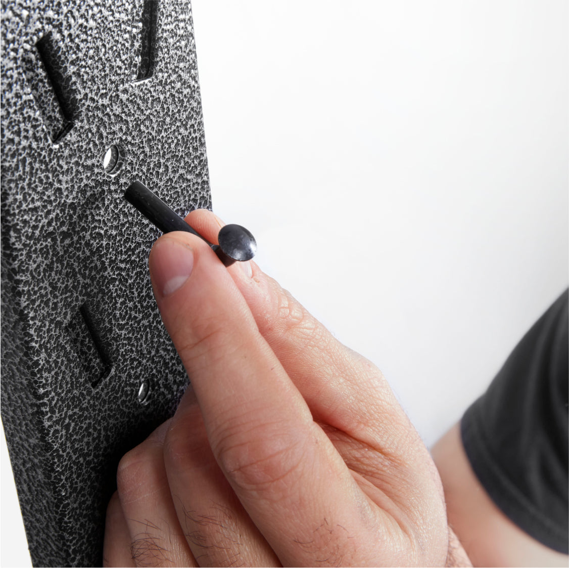 A person using the Secure Locking Pins.