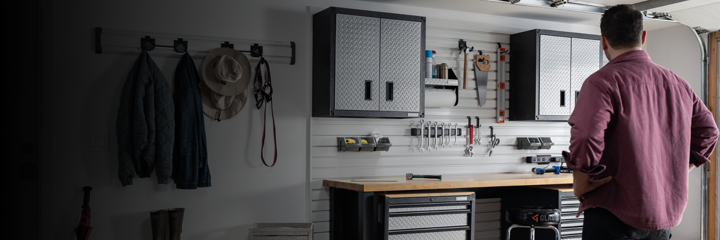 A dad looking at his organized Gladiator® storage solutions