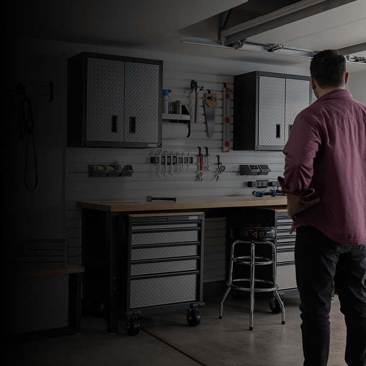 A dad looking at his organized Gladiator® storage solutions
