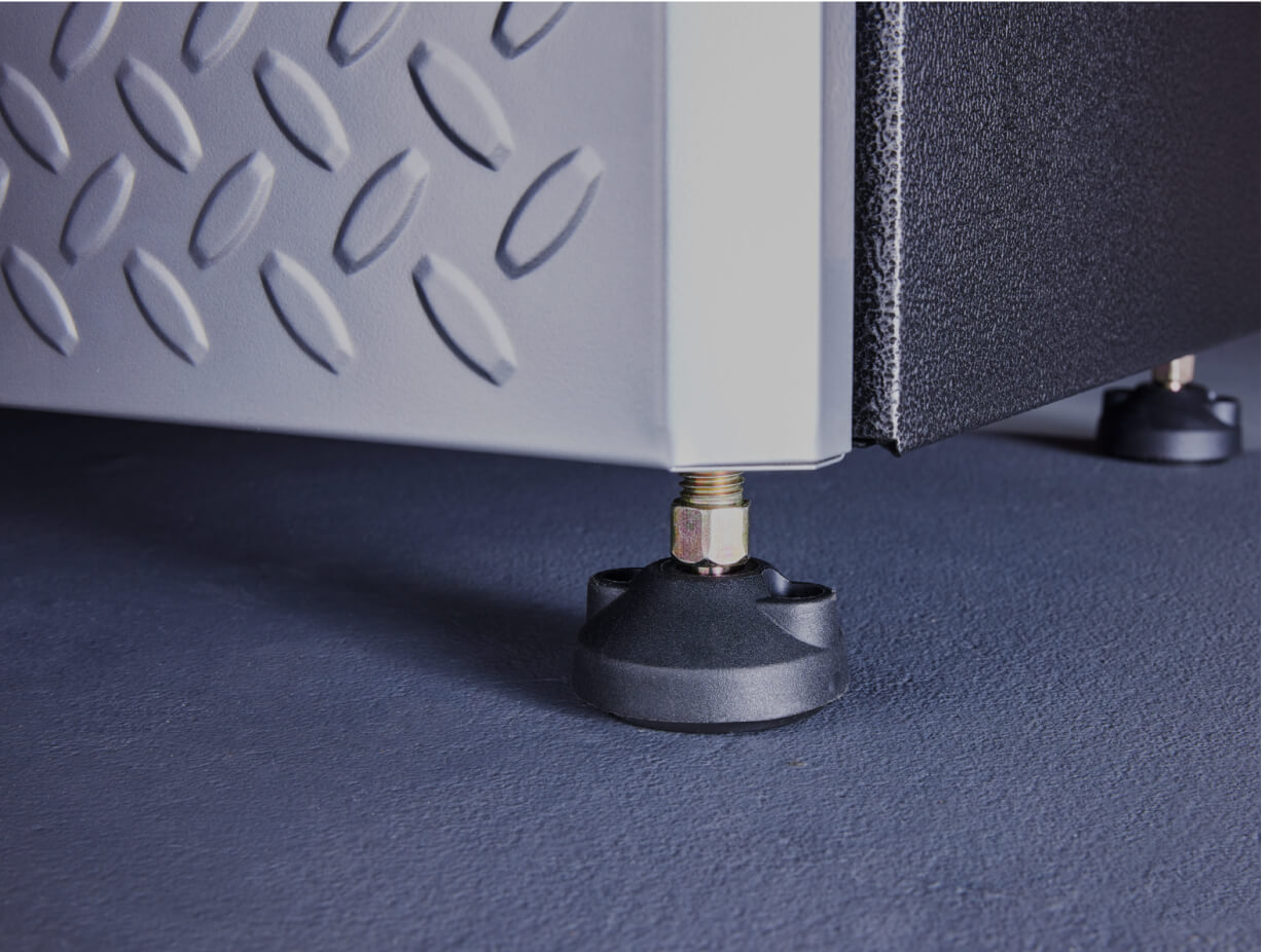 A closeup of a self-leveling foot on a Gladiator® cabinet.