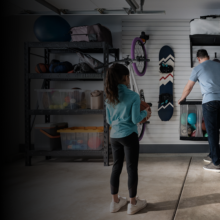 Two people organizing their garage using Gladiator® GearWall®.
